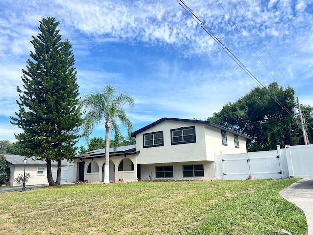 view of front of home with a garage and a front lawn