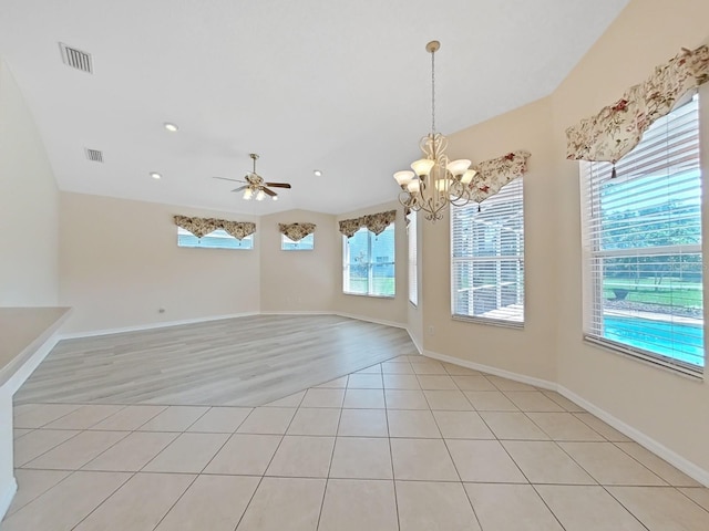 tiled empty room featuring ceiling fan with notable chandelier