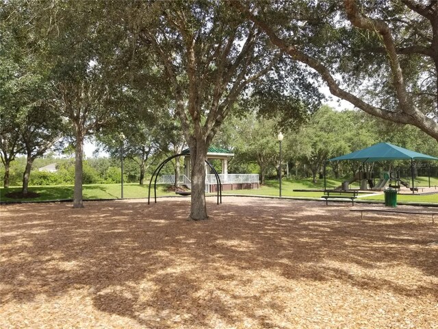 view of property's community featuring a playground and a yard