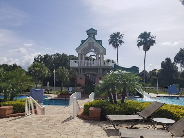 view of community featuring a swimming pool and a patio area