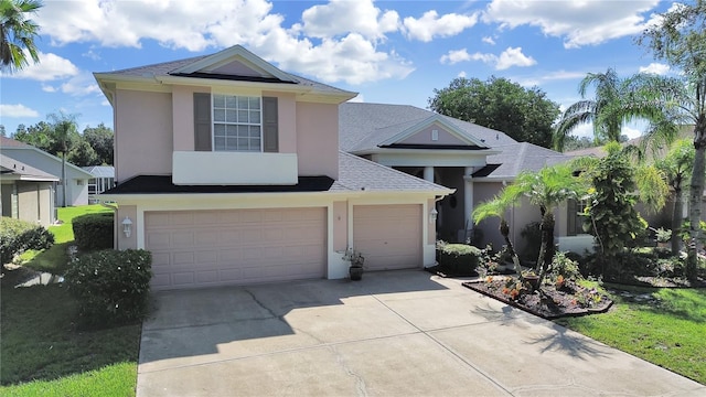 view of front of property featuring a garage and a front yard