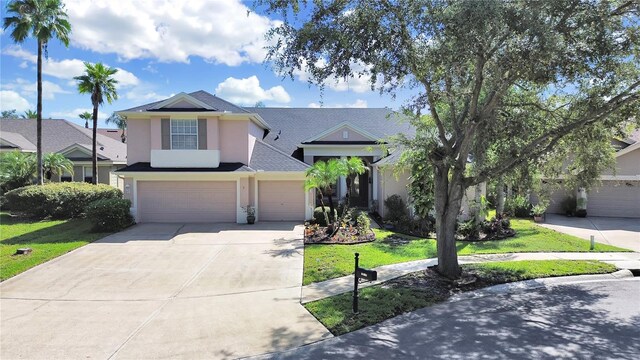 view of front of house featuring a front lawn and a garage