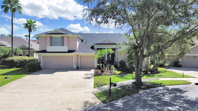 view of front of home with a front yard and a garage