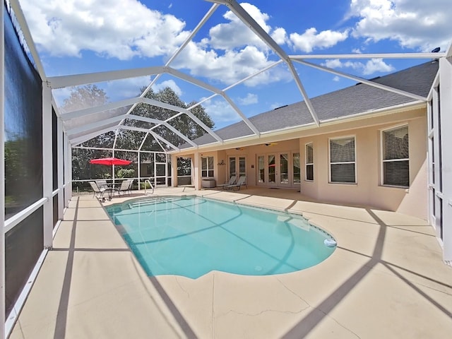 view of pool featuring french doors, a lanai, ceiling fan, and a patio area