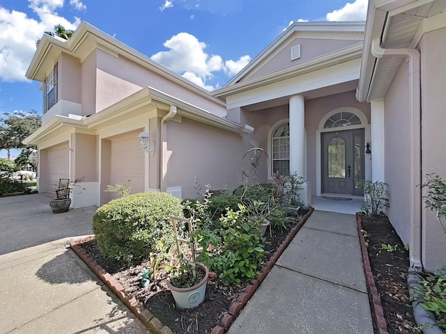 doorway to property with a garage