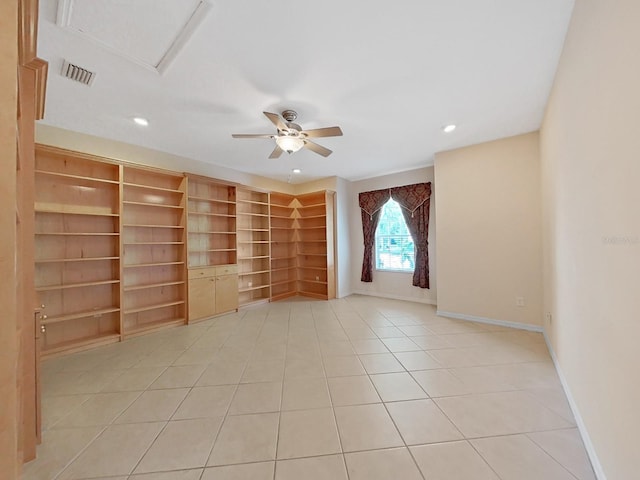 tiled spare room with ceiling fan