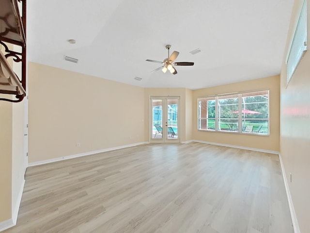 spare room with light wood-type flooring, french doors, and ceiling fan