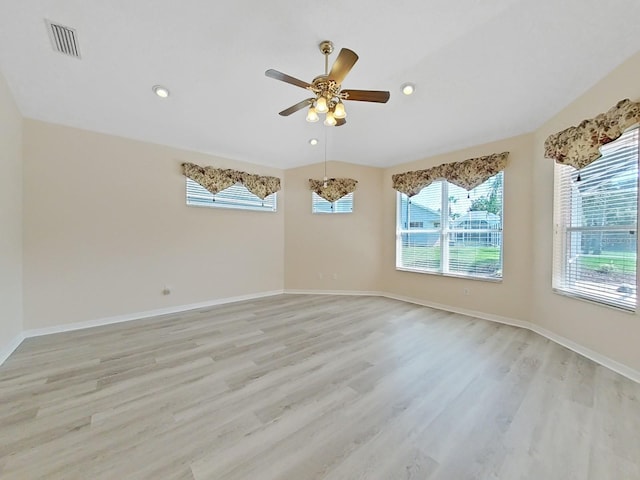 spare room with ceiling fan, plenty of natural light, and light hardwood / wood-style flooring