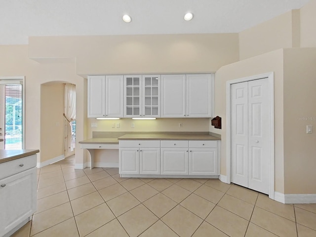 kitchen with light tile patterned floors and white cabinets