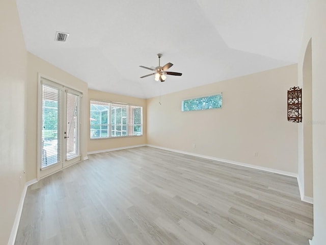 empty room featuring ceiling fan, light hardwood / wood-style flooring, and vaulted ceiling