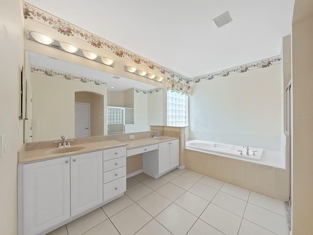 bathroom with plus walk in shower, vanity, and tile patterned flooring