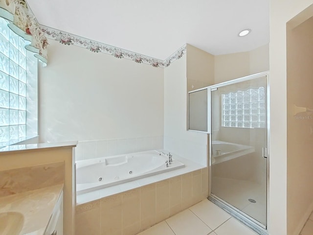 bathroom with plus walk in shower, vanity, and tile patterned flooring