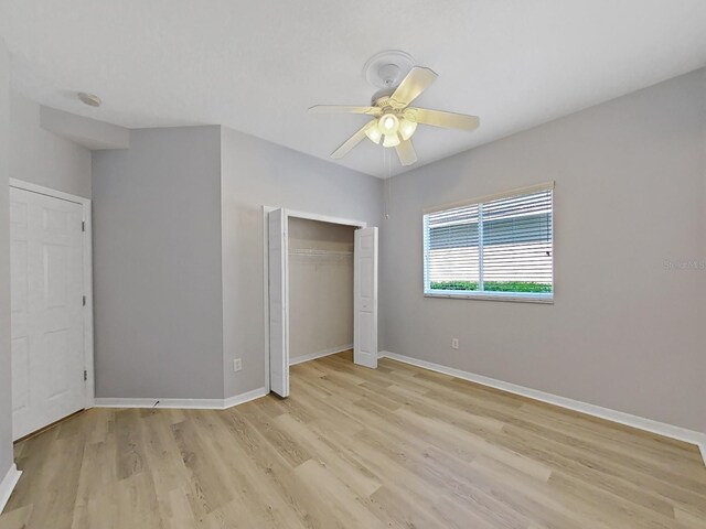 unfurnished bedroom featuring ceiling fan, light hardwood / wood-style flooring, and a closet