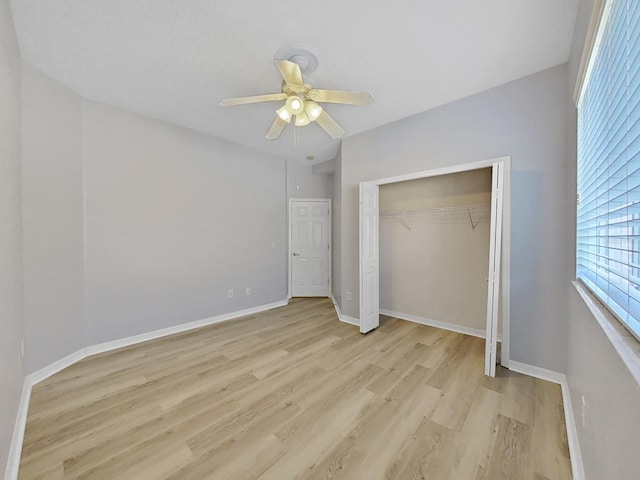 unfurnished bedroom with ceiling fan, light hardwood / wood-style flooring, and a closet