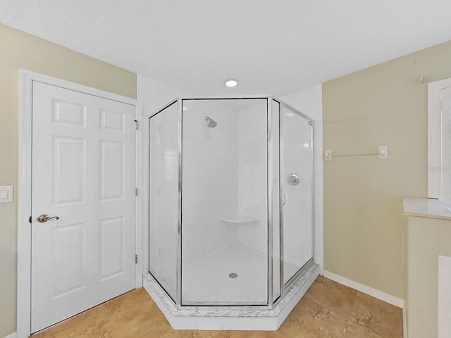 bathroom featuring a shower with shower door