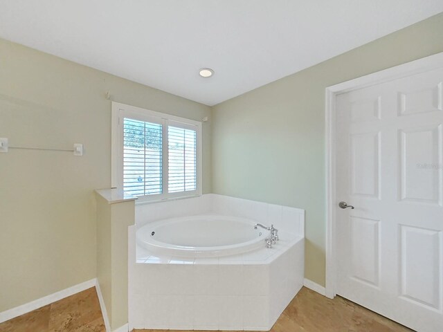 bathroom with tiled tub