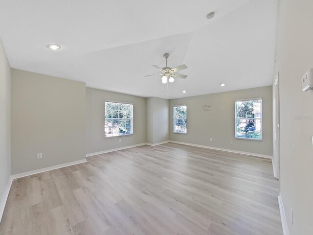 spare room featuring ceiling fan, plenty of natural light, and light hardwood / wood-style floors