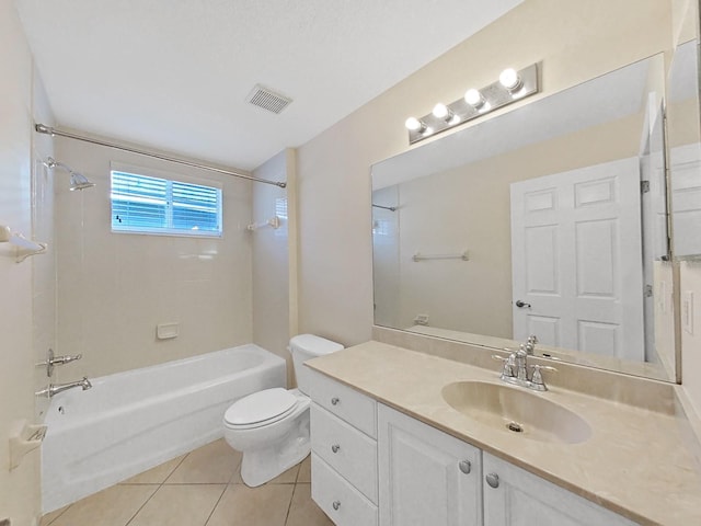 full bathroom featuring tiled shower / bath combo, tile patterned floors, toilet, and vanity