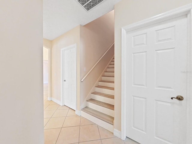 stairway featuring tile patterned floors