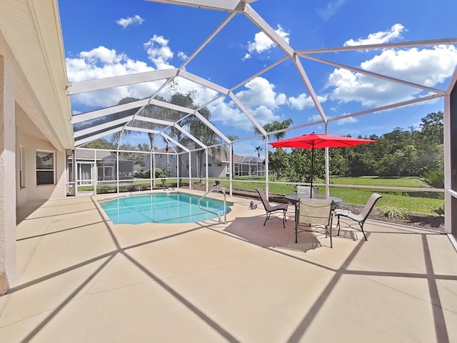 view of swimming pool with a patio and glass enclosure