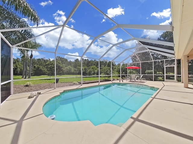 view of swimming pool featuring a patio area and a lanai