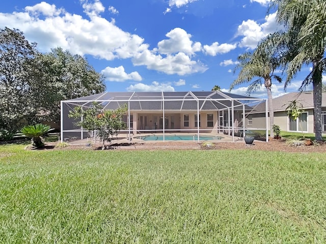 rear view of property with a lawn and a lanai