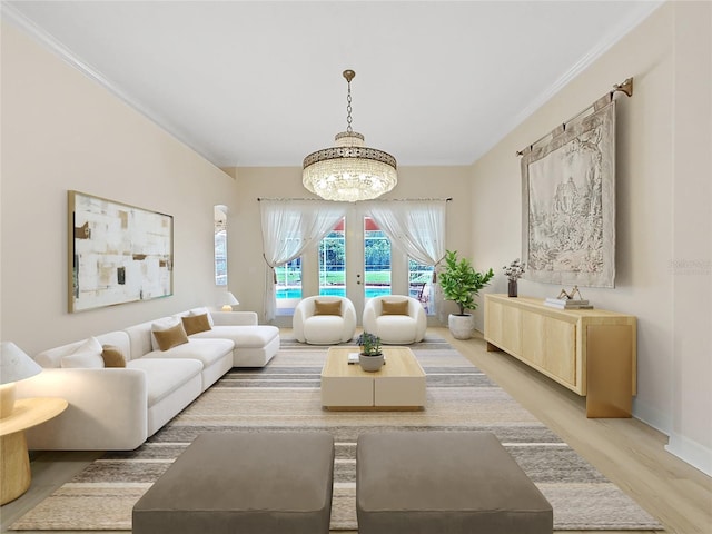 living room with ornamental molding, a chandelier, and wood-type flooring