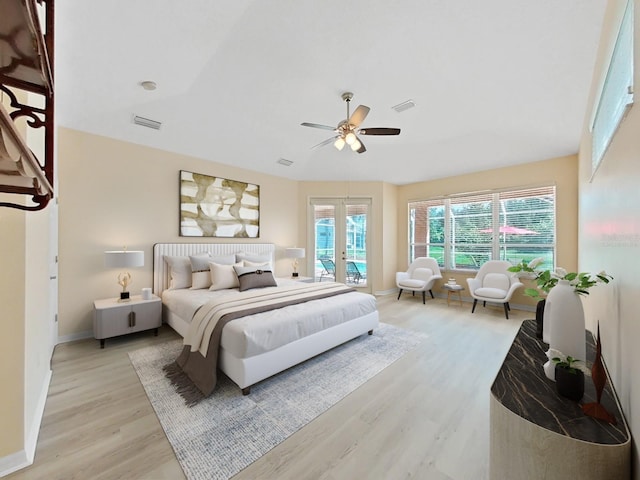 bedroom featuring ceiling fan, light hardwood / wood-style flooring, french doors, and access to exterior