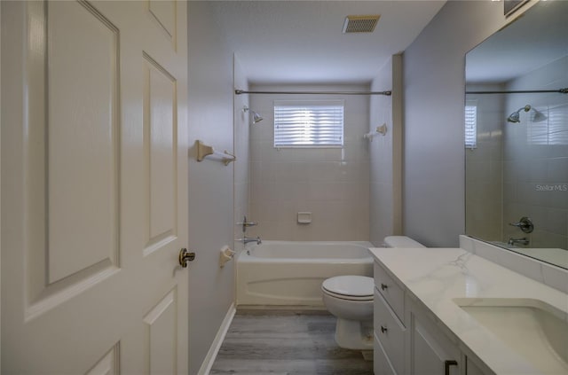 19334 Autumn Woods Ave, Tampa, FL 33647 - bathroom with visible vents, shower / tub combination, wood finished floors, and toilet