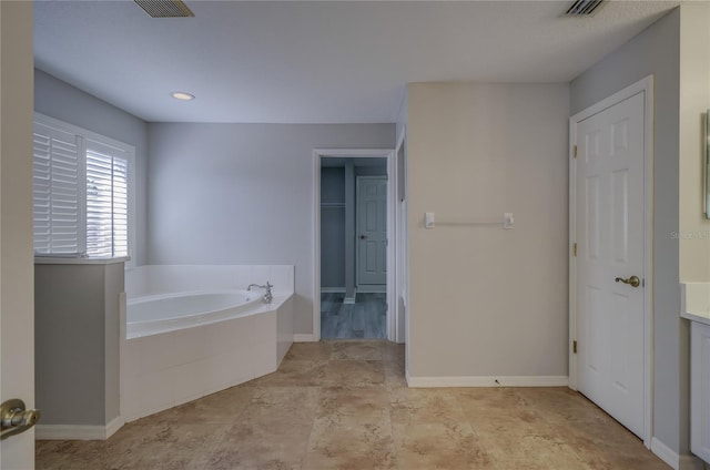 19334 Autumn Woods Ave, Tampa, FL 33647 - full bathroom featuring baseboards, a garden tub, and visible vents