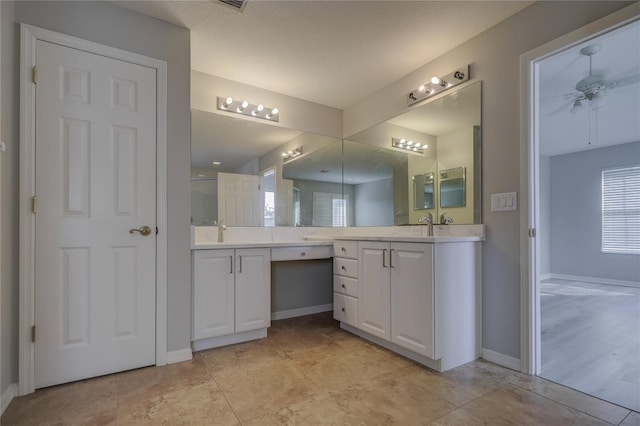 19334 Autumn Woods Ave, Tampa, FL 33647 - bathroom featuring a sink, baseboards, a ceiling fan, and two vanities
