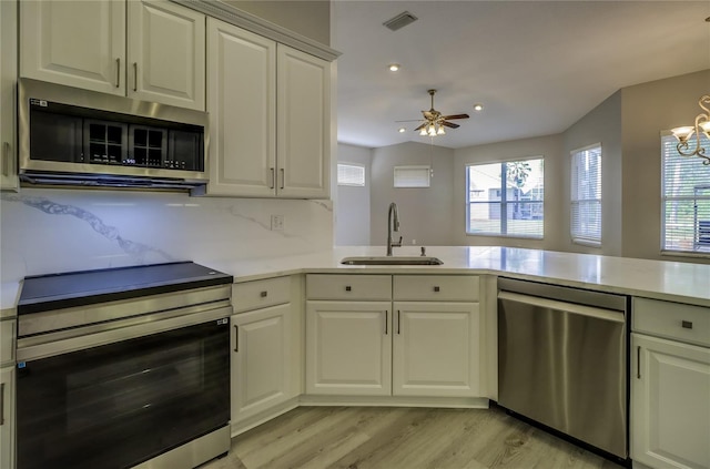 19334 Autumn Woods Ave, Tampa, FL 33647 - kitchen featuring a sink, light countertops, light wood-style flooring, stainless steel appliances, and visible vents