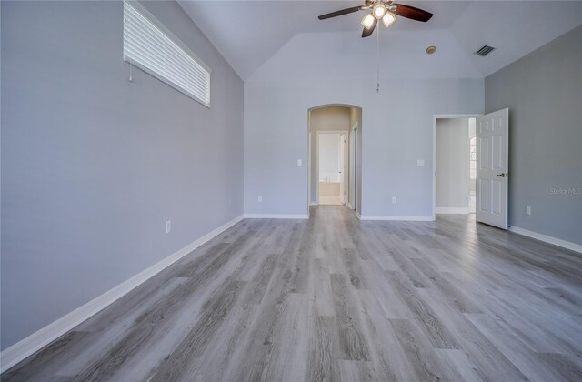19334 Autumn Woods Ave, Tampa, FL 33647 - unfurnished room featuring visible vents, wood finished floors, ceiling fan, high vaulted ceiling, and arched walkways
