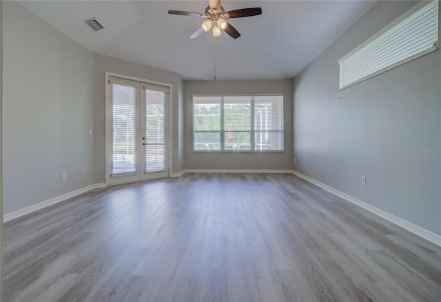 19334 Autumn Woods Ave, Tampa, FL 33647 - spare room featuring visible vents, ceiling fan, wood finished floors, and french doors