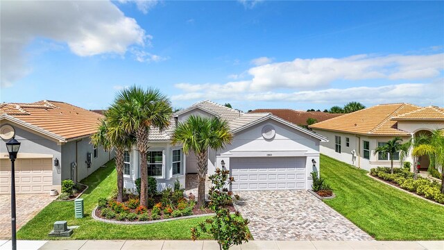 view of front of property with a garage and a front yard