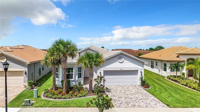 view of front facade with a garage and a front lawn