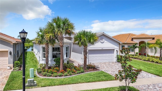 view of front of property with a garage and a front yard