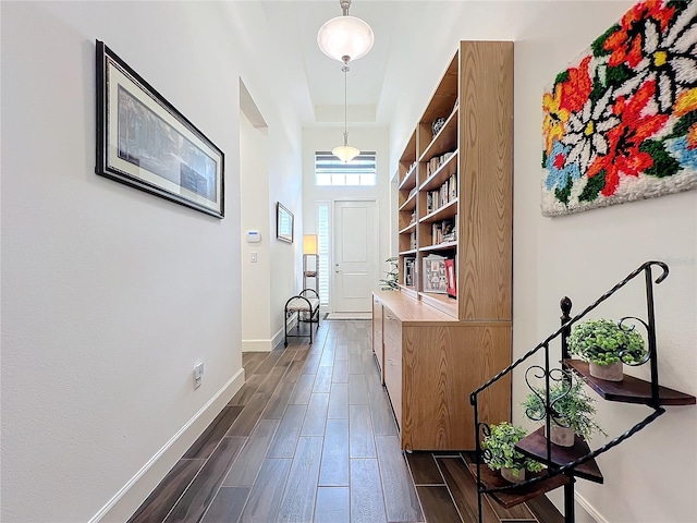 hallway with a tray ceiling