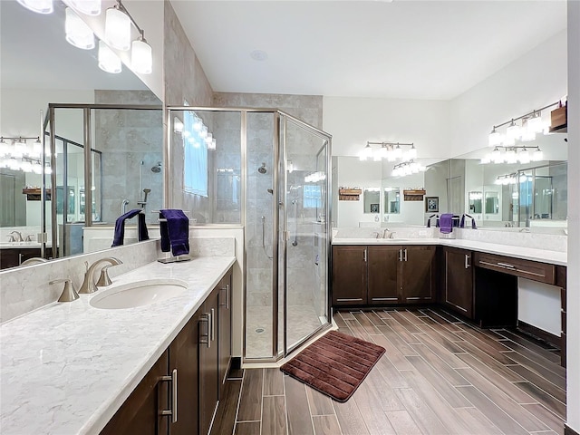 bathroom featuring vanity and an enclosed shower