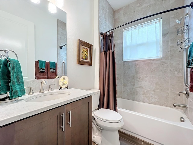 full bathroom with shower / bathtub combination with curtain, vanity, and toilet