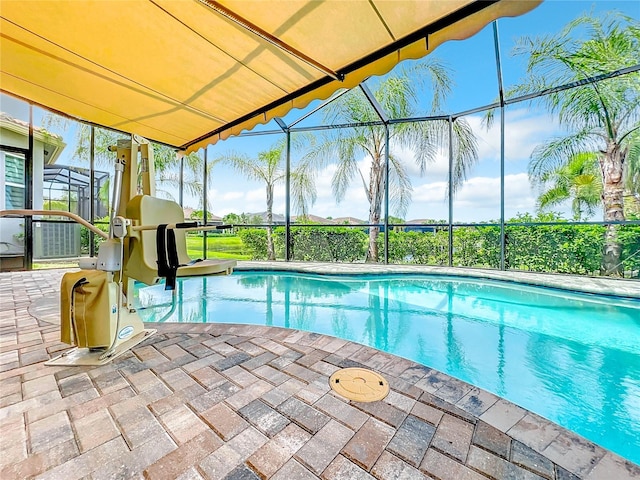 view of swimming pool featuring a lanai and a patio