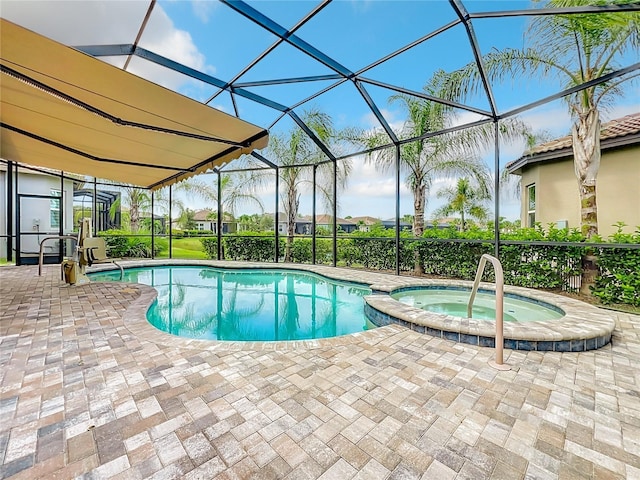 view of swimming pool featuring an in ground hot tub, a lanai, and a patio area