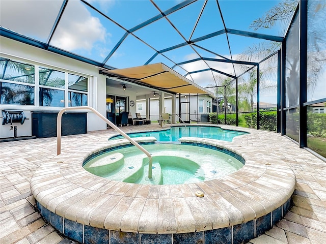 view of swimming pool with a patio, glass enclosure, and an in ground hot tub