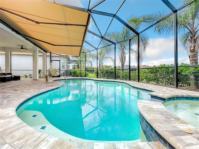 view of pool with a patio area and glass enclosure