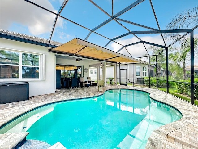 view of pool with central AC unit, a lanai, and a patio