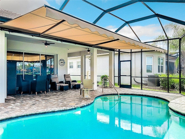 view of swimming pool with central AC, a patio, ceiling fan, and glass enclosure