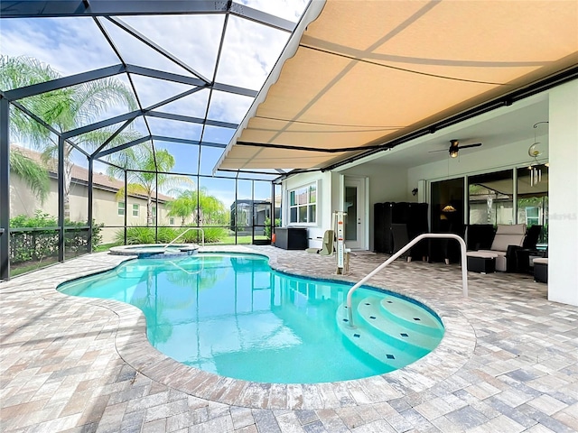 view of pool featuring a patio, a lanai, and an in ground hot tub