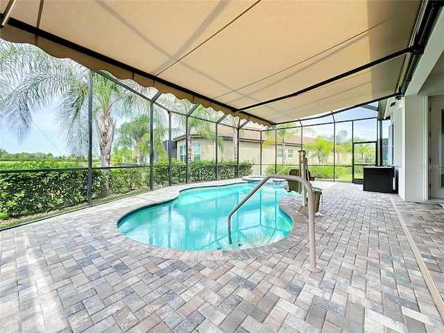 view of pool with a patio and a lanai