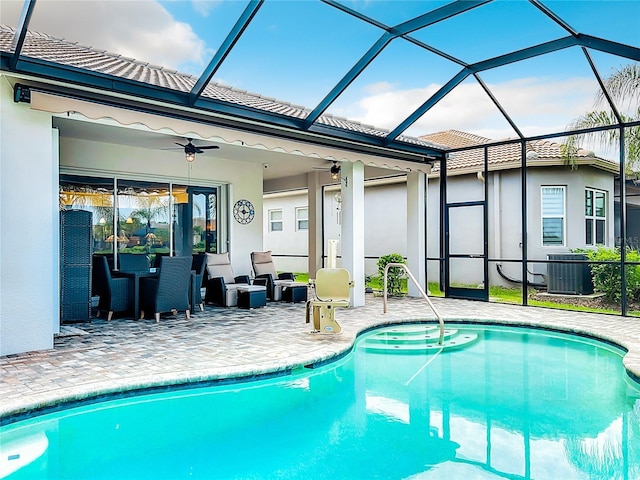 view of swimming pool featuring ceiling fan, a lanai, central AC unit, and a patio