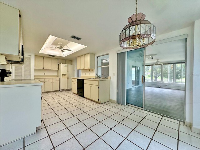 kitchen featuring ceiling fan, sink, black dishwasher, white refrigerator with ice dispenser, and light hardwood / wood-style flooring